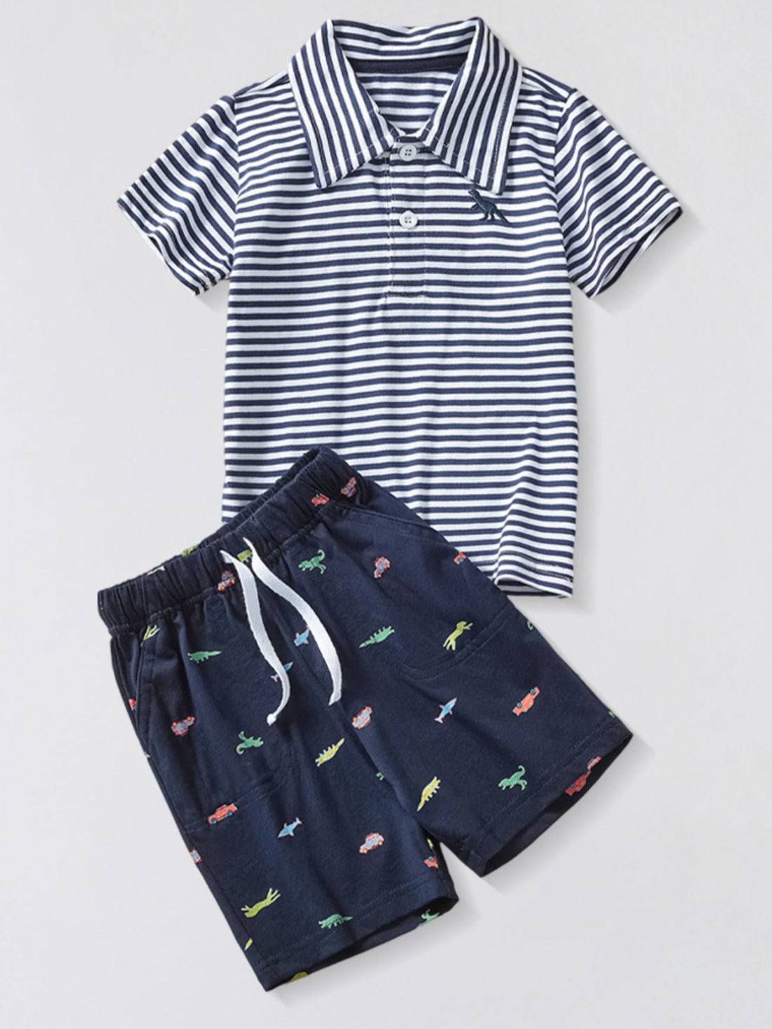 Toddler navy shorts with dinosaur and car print and striped polo shirt.