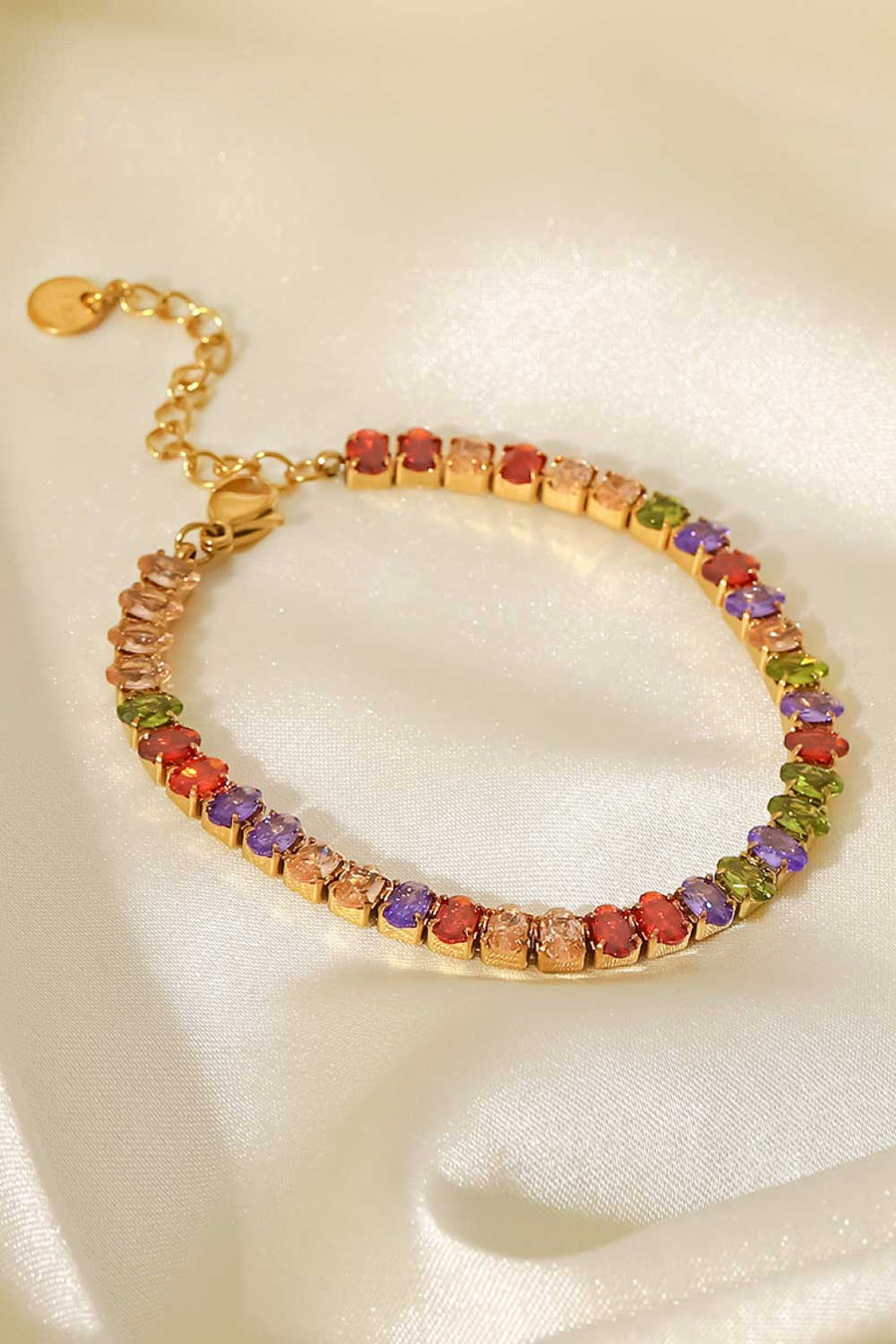 18K gold plated tennis bracelet with multi-colored zircon stones and adjustable clasp.