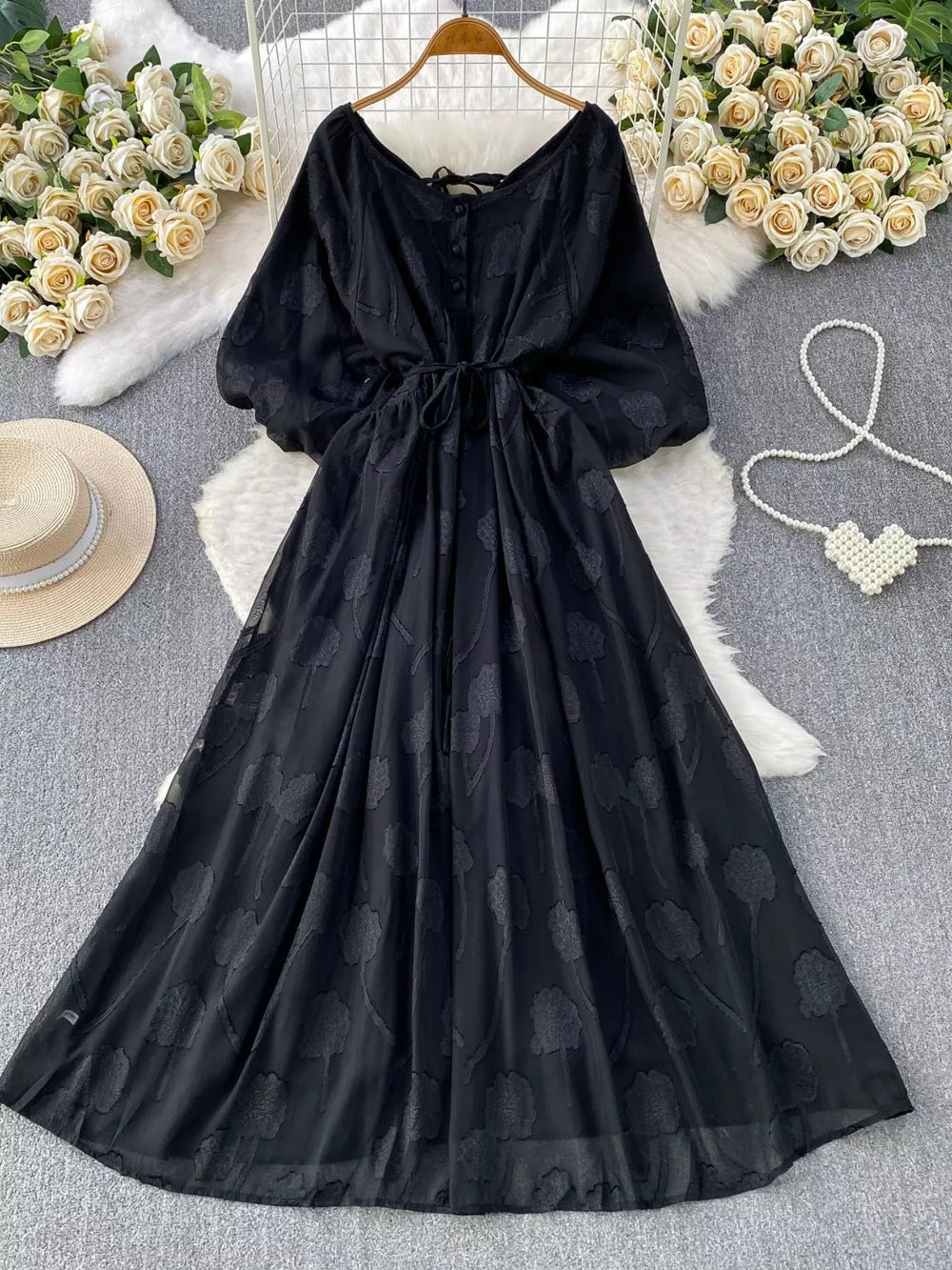 Black chiffon maxi dress with floral embroidery, V-neck, button front, and tie waist.