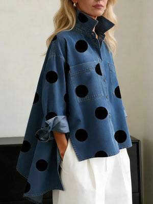 black button-up shirt featuring buttoned and polka-dot