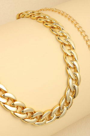Gold chunky curb chain belt with a polished finish.
