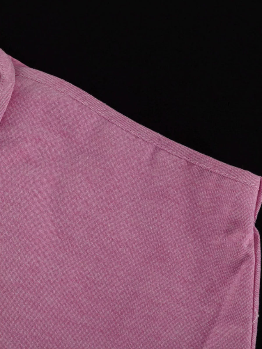 Pink polo shirt with textured fabric and a classic collar.