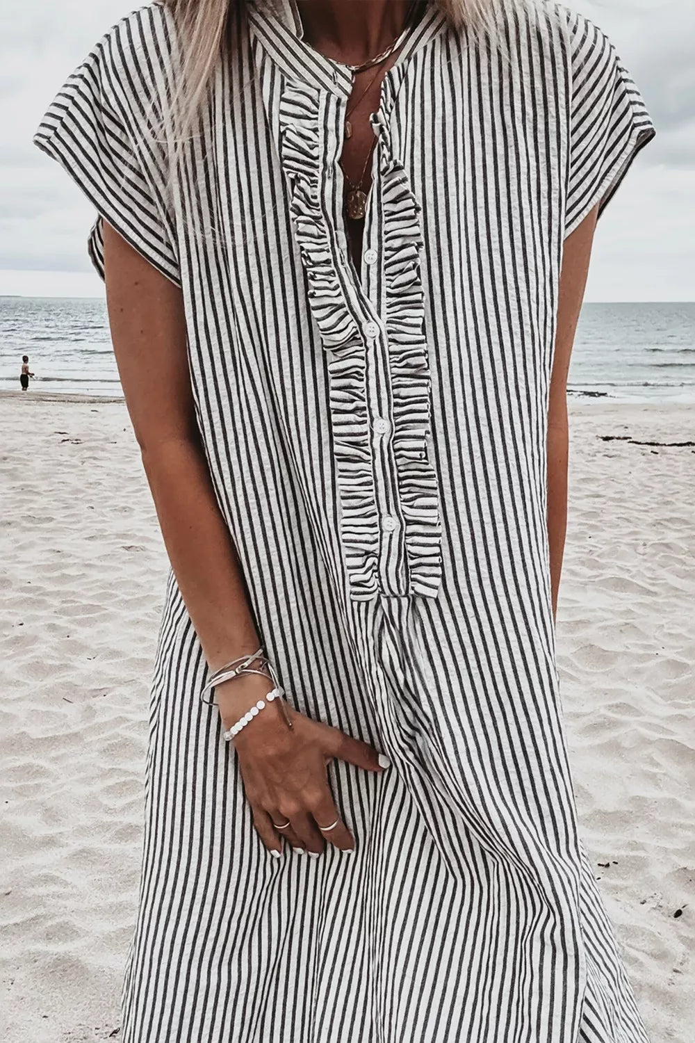 Black and white striped maternity swim dress with ruffle button-down front and cap sleeves.