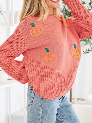 Burnt coral knit sweater with embroidered pumpkins and a ribbed hem.