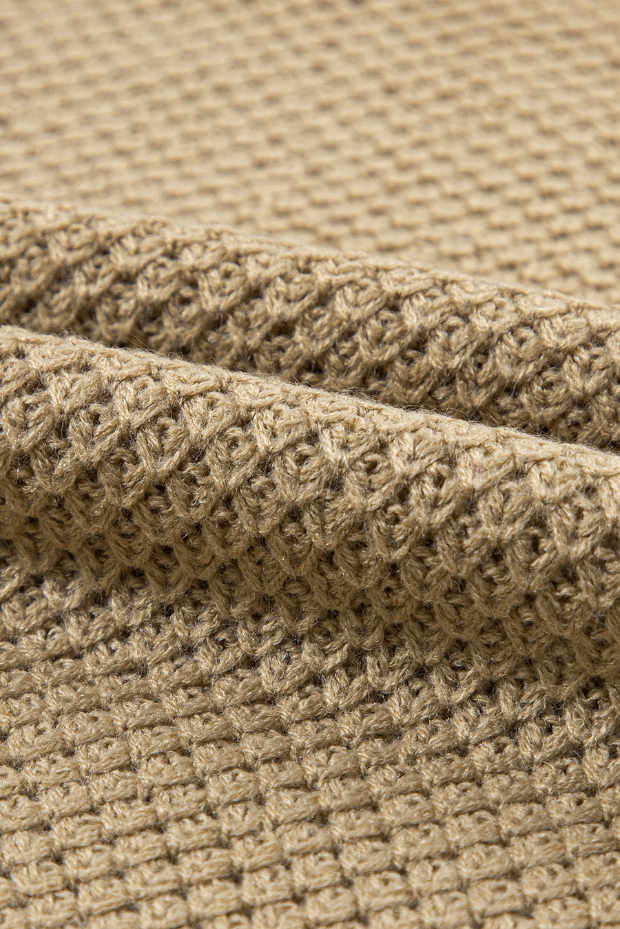 Khaki textured knit turtleneck sweater with cap sleeves and a waffle knit pattern.