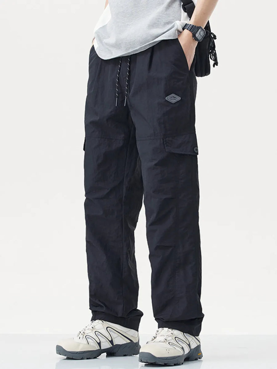 Black relaxed fit cargo sweatpants with drawstring and side pockets.