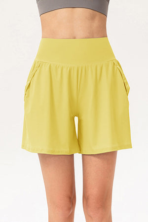 Yellow active shorts with layered pockets and a high waistband.