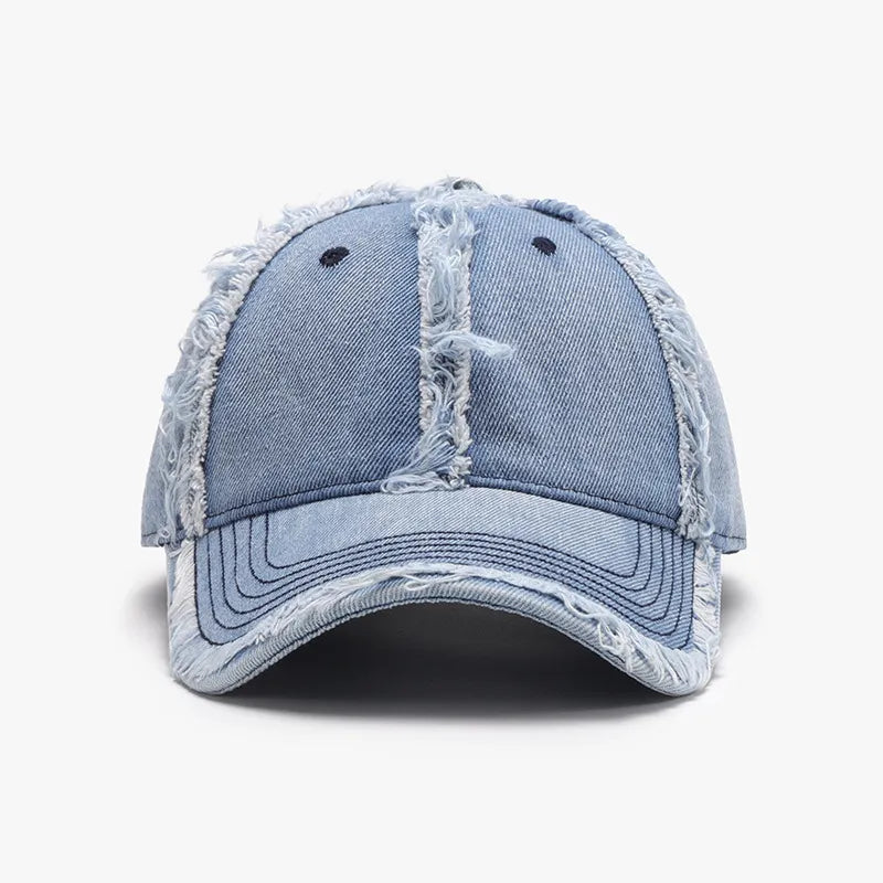 Light wash denim baseball cap with distressed frayed edges and stitching detail