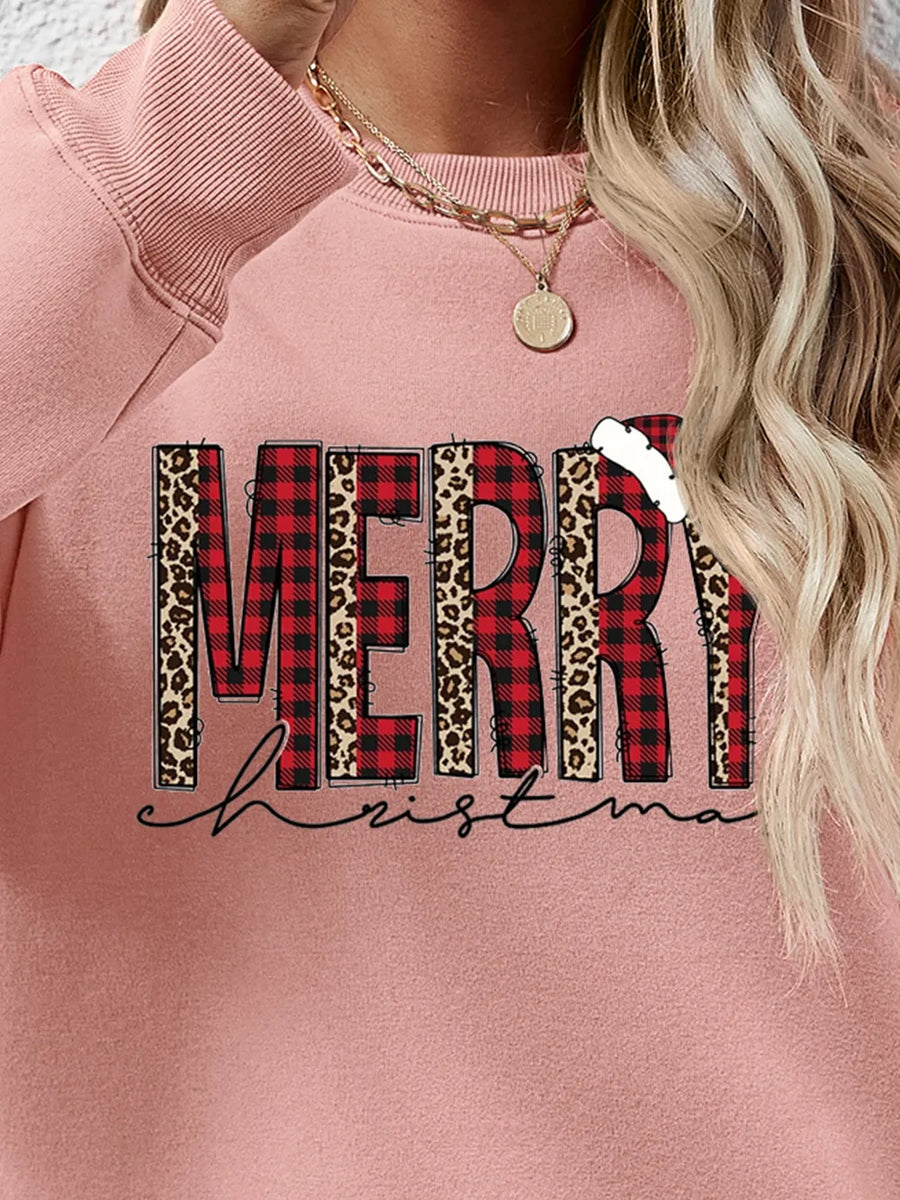 Blush pink sweatshirt with "Merry Christmas" graphic in buffalo plaid and leopard print.