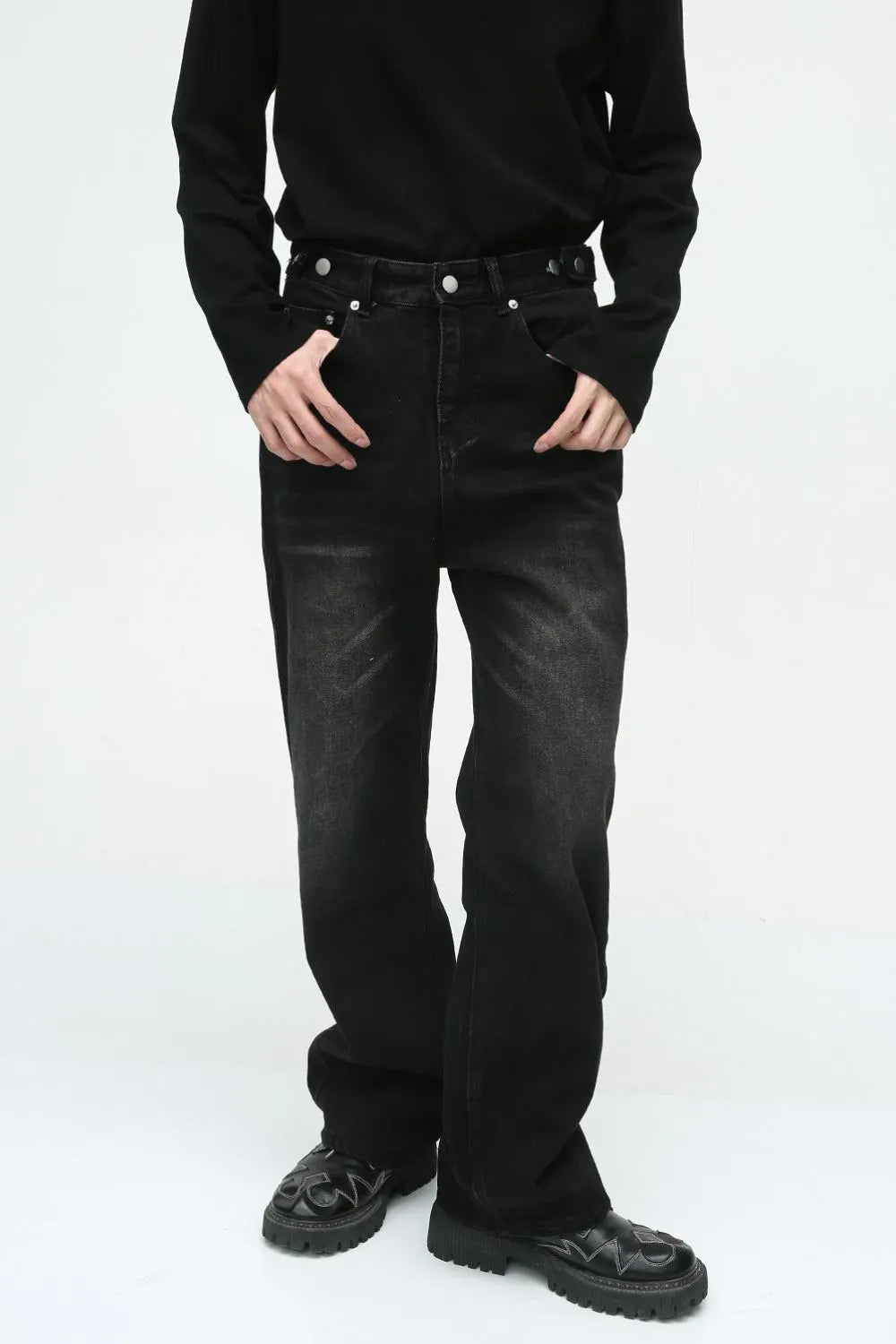 Dark vintage wash relaxed fit denim jeans with button fly and distressed details.