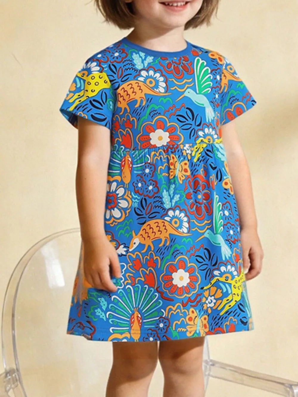 Blue cotton toddler dress with whimsical animal and floral print, short sleeves, round neck.