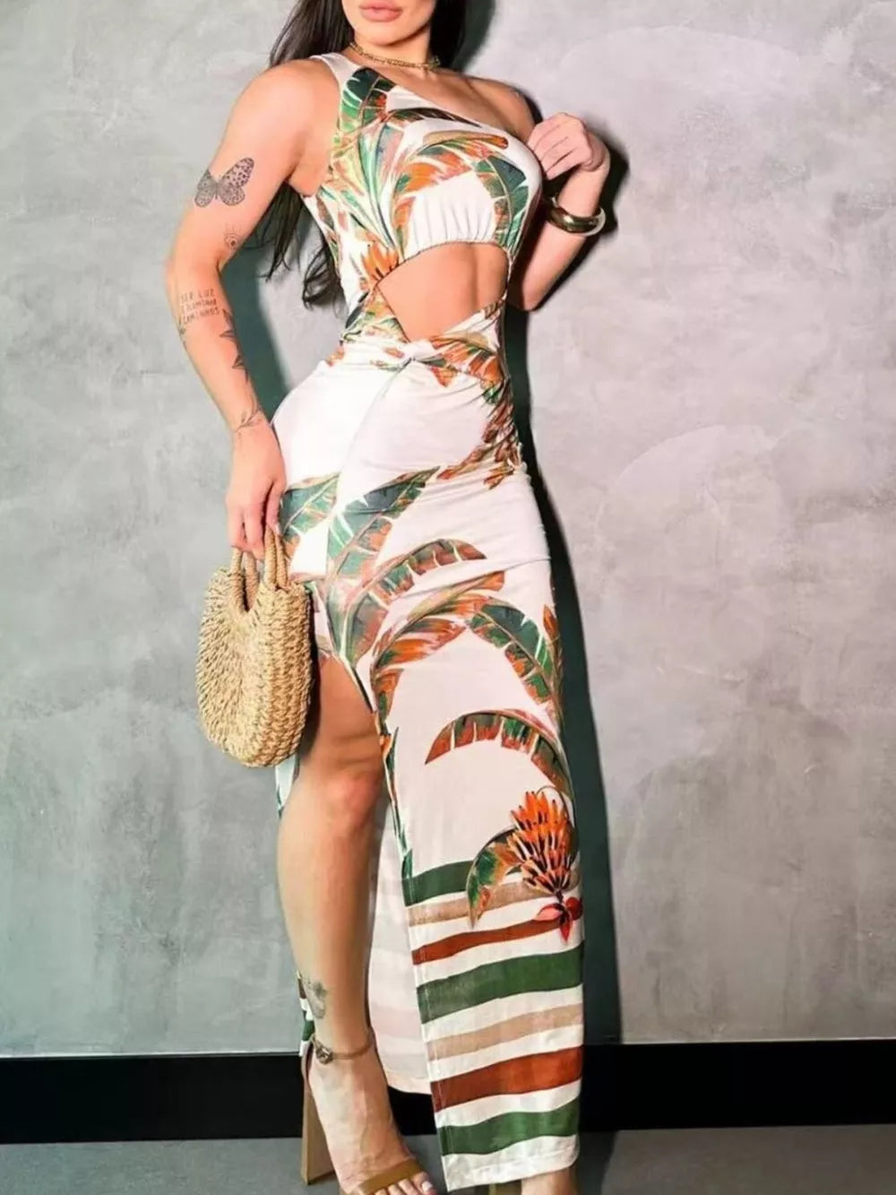 Tropical cutout maxi dress with slit and one-shoulder neckline in white with leaf print.
