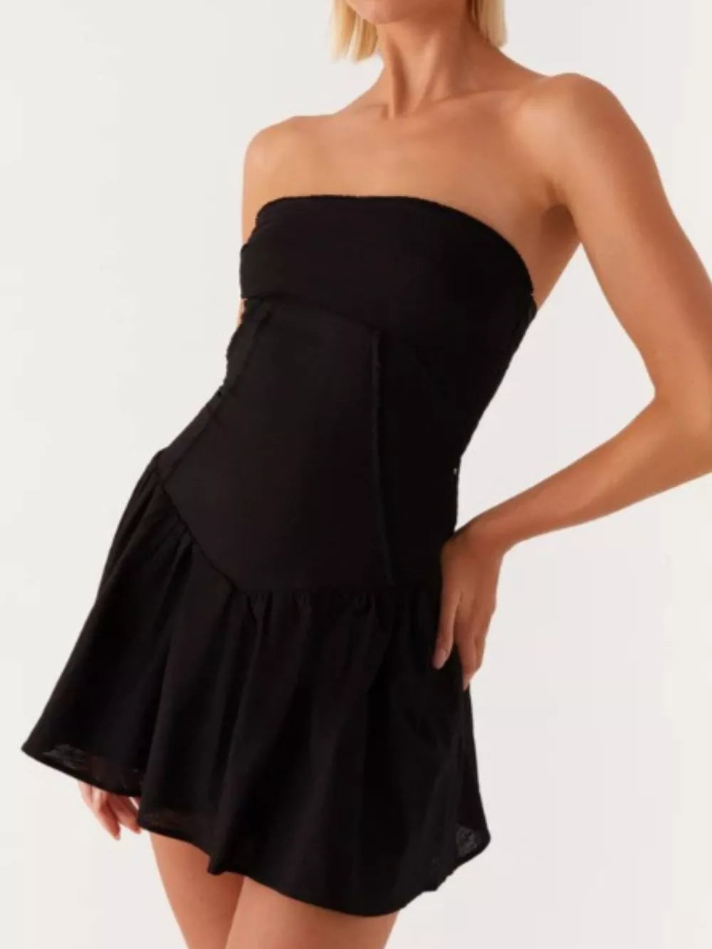 Black ruffled tube dress with back tie detail and tiered skirt.