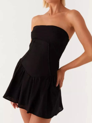 Black ruffled tube dress with back tie detail and tiered skirt.