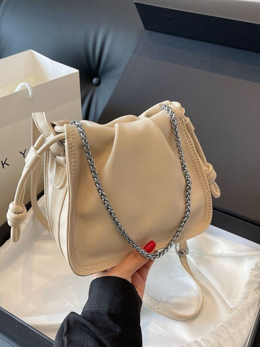 Elegant ruched off-white pu leather crossbody bag with silver chain detail