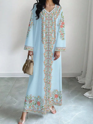 Sky blue floral maxi dress with embroidered details and long sleeves.
