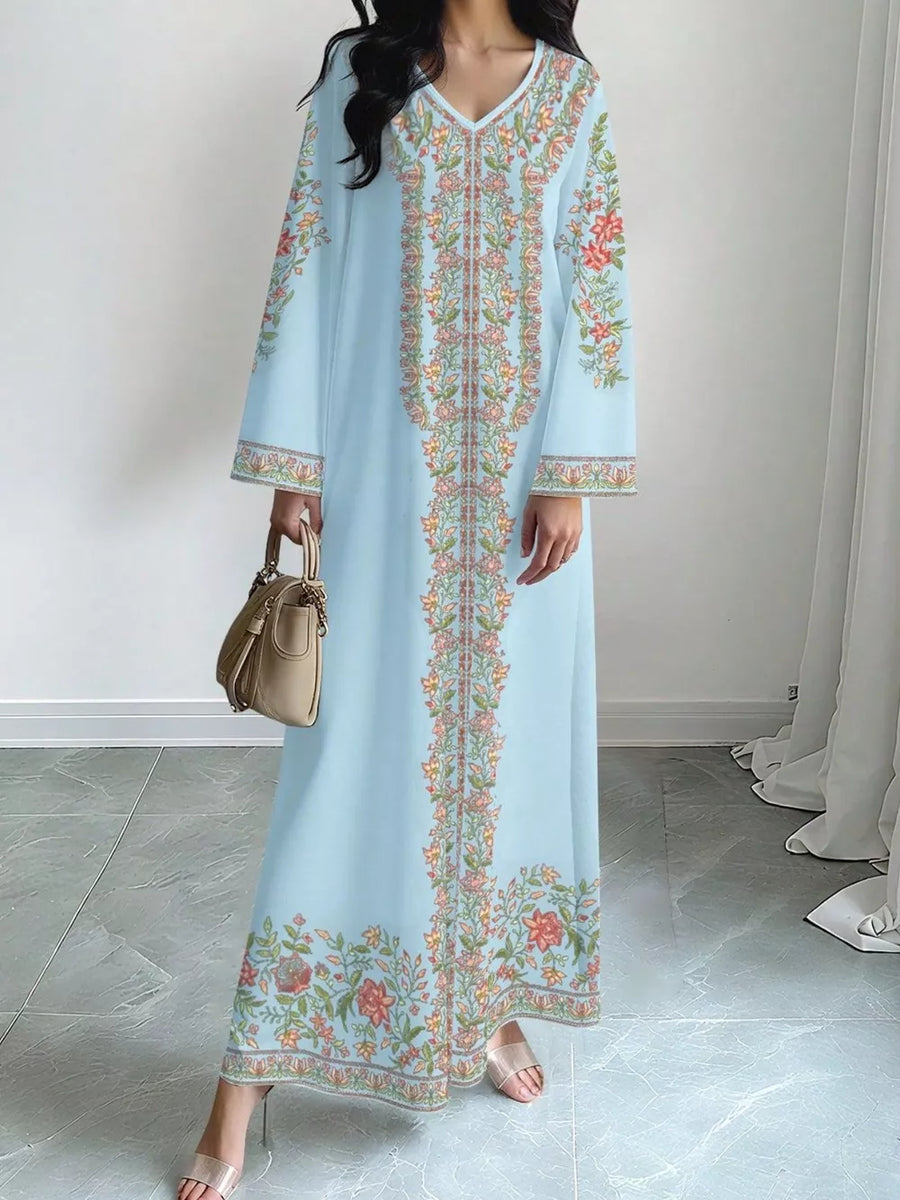 Sky blue floral maxi dress with embroidered details and long sleeves.