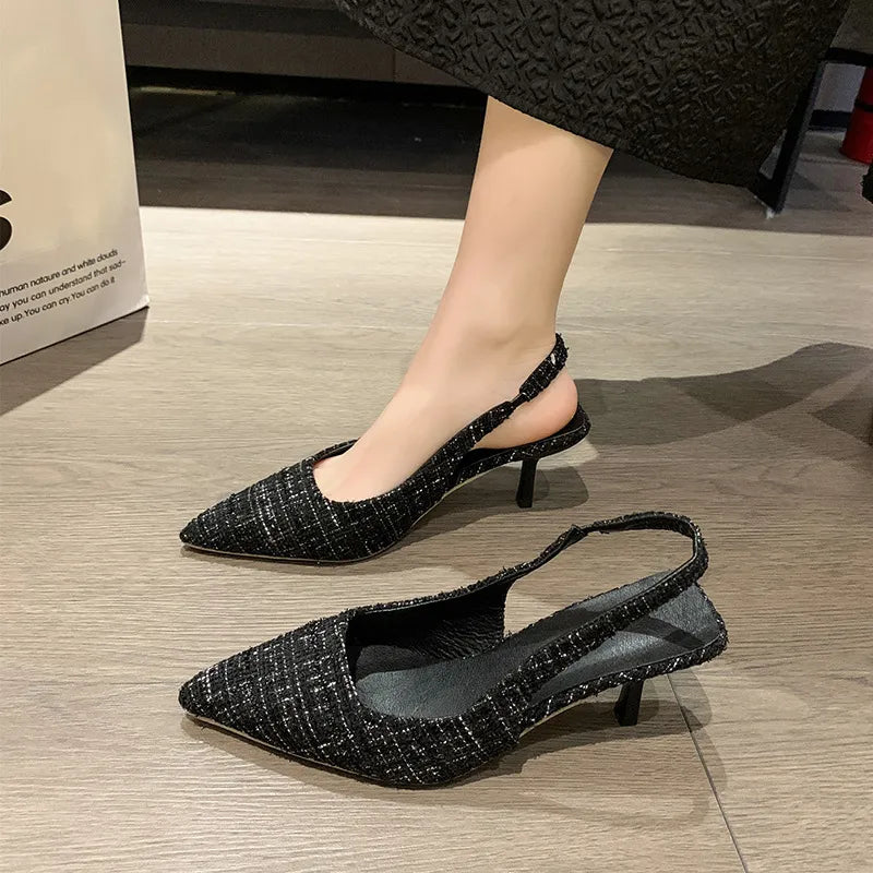Black textured tweed slingback kitten heels with pointed toe and kitten heel.