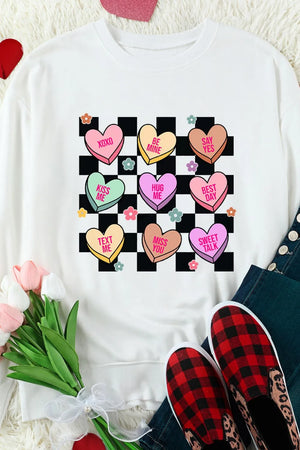 White sweatshirt with conversation heart graphic and checkerboard pattern.