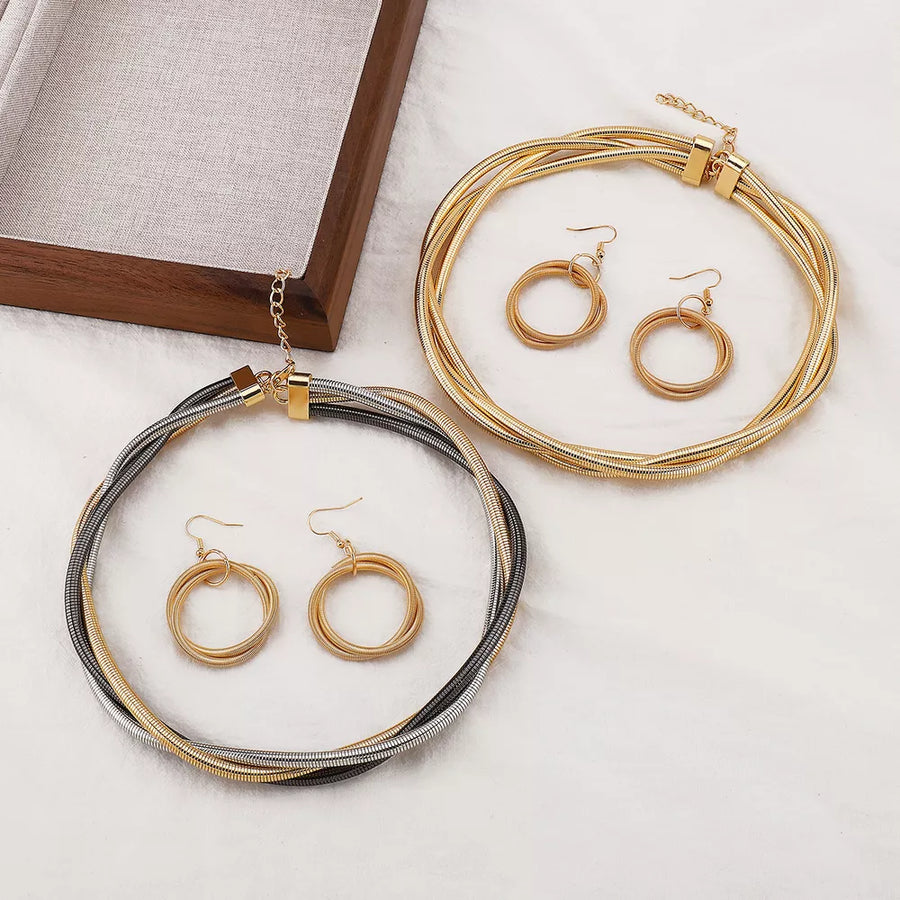 jewelry set in gold featuring multi-layered and layered fit
