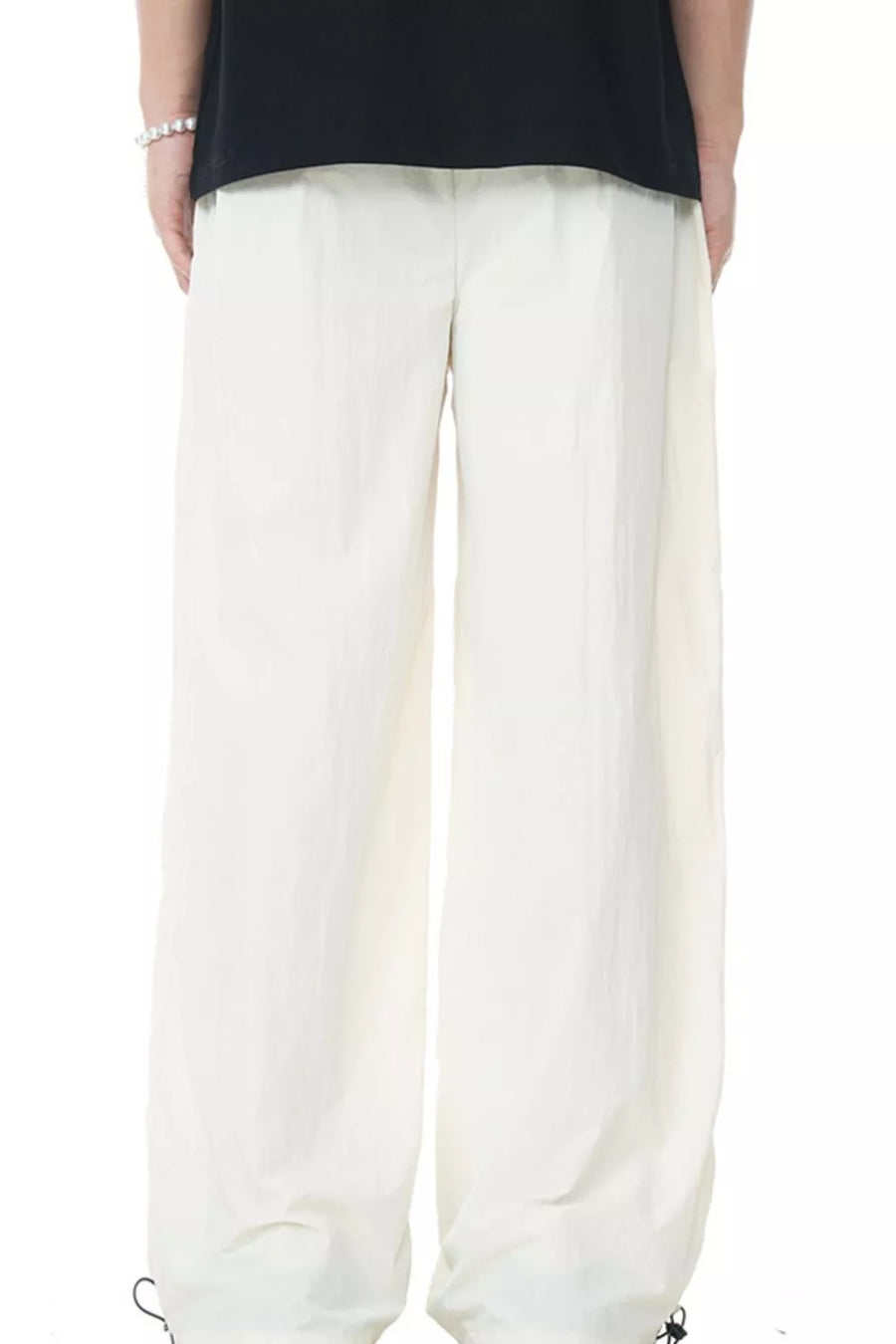 Men's off-white casual flowing wide-leg sweatpants with drawstring cuffs.