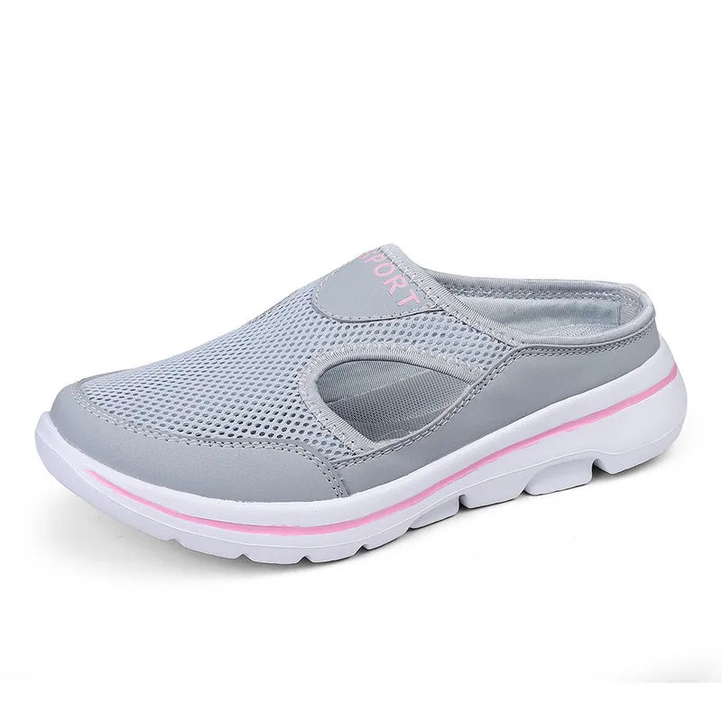 Sporty mesh cut-out mule slipper in gray with pink trim and white sole.