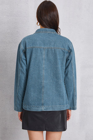 Denim blazer in medium wash with tailored seam detailing and button closure.