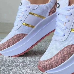 Chic round toe platform sneakers in white with pink logo accents and gold stripes.