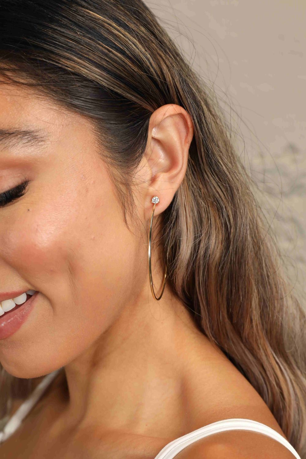 Gold hoop earrings with clear stud detail