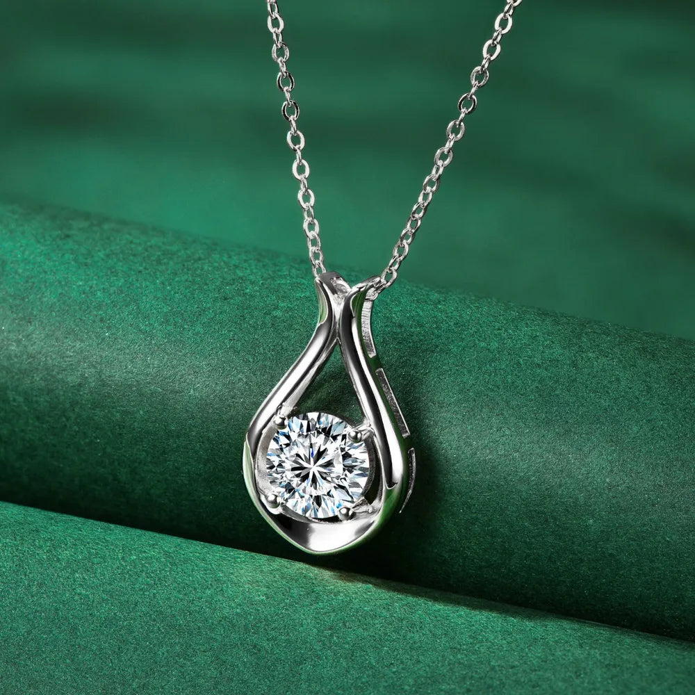Sterling silver teardrop pendant necklace with a round moissanite stone