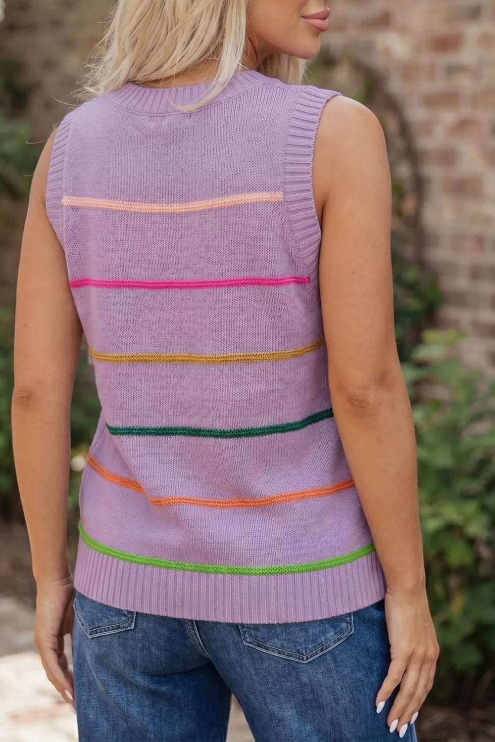 Lavender knit sweater vest with colorful horizontal stripes and ribbed trim.