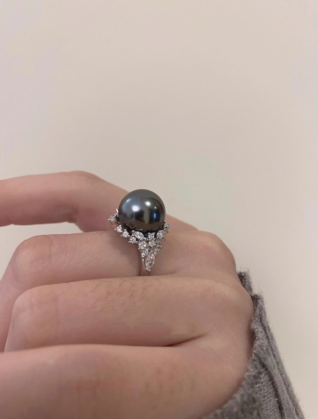Luminous gray pearl and silver ring with diamond accents.