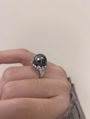 Luminous gray pearl and silver ring with diamond accents.