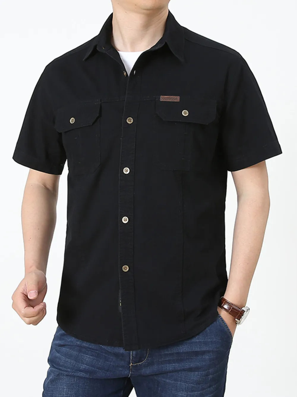 Men's black short sleeve cotton shirt with buttoned chest pockets and a small leather patch detail.
