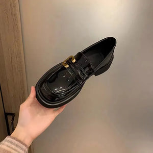 Patent leather chunky loafers in black with gold buckle detail