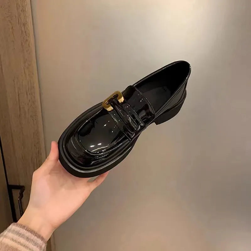 Patent leather chunky loafers in black with gold buckle detail