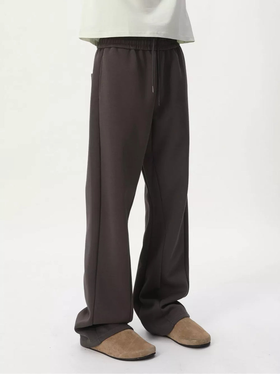 Relaxed fit dark gray sweatpants with adjustable drawstring waist and side pockets.