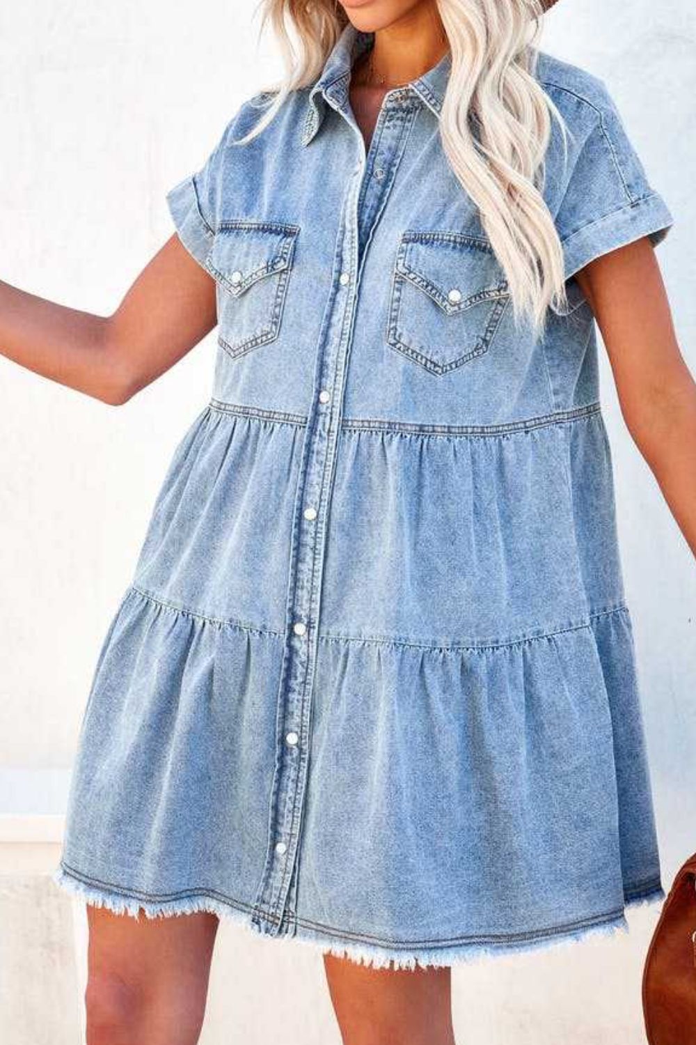 Tiered light blue denim shirtdress with frayed hem and button front.