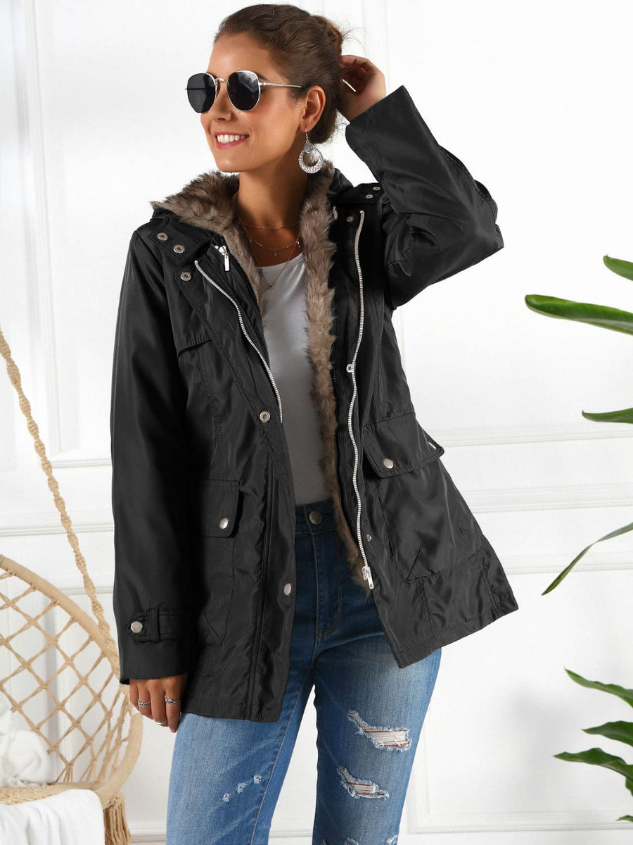 Black belted utility parka with faux fur lining and hood, featuring multiple pockets.