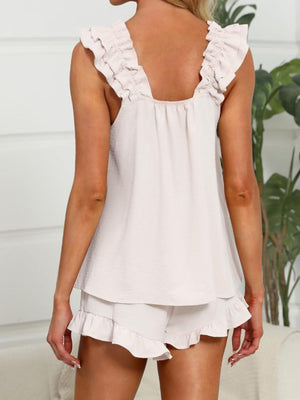 Apricot ruffled top and shorts pajama set with ruffled trim.