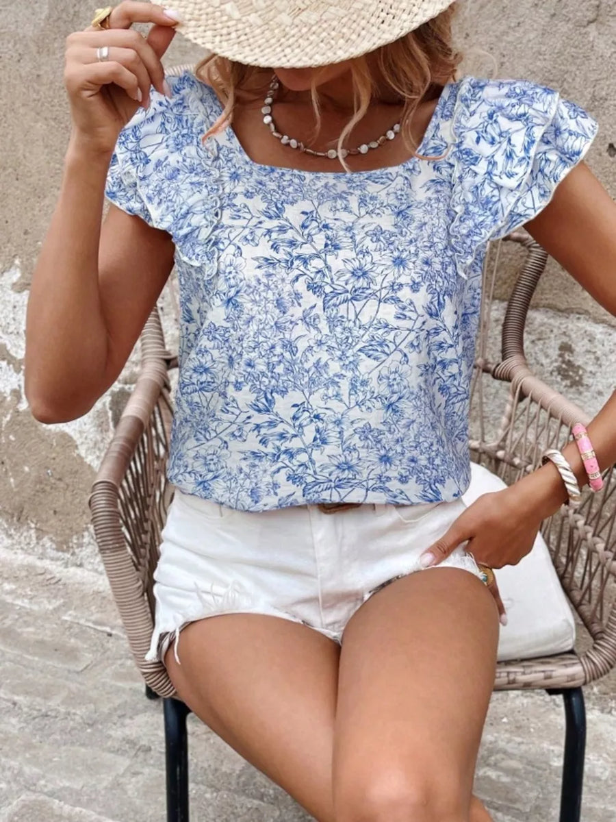 Blue floral ruffle blouse with square neckline and short sleeves.