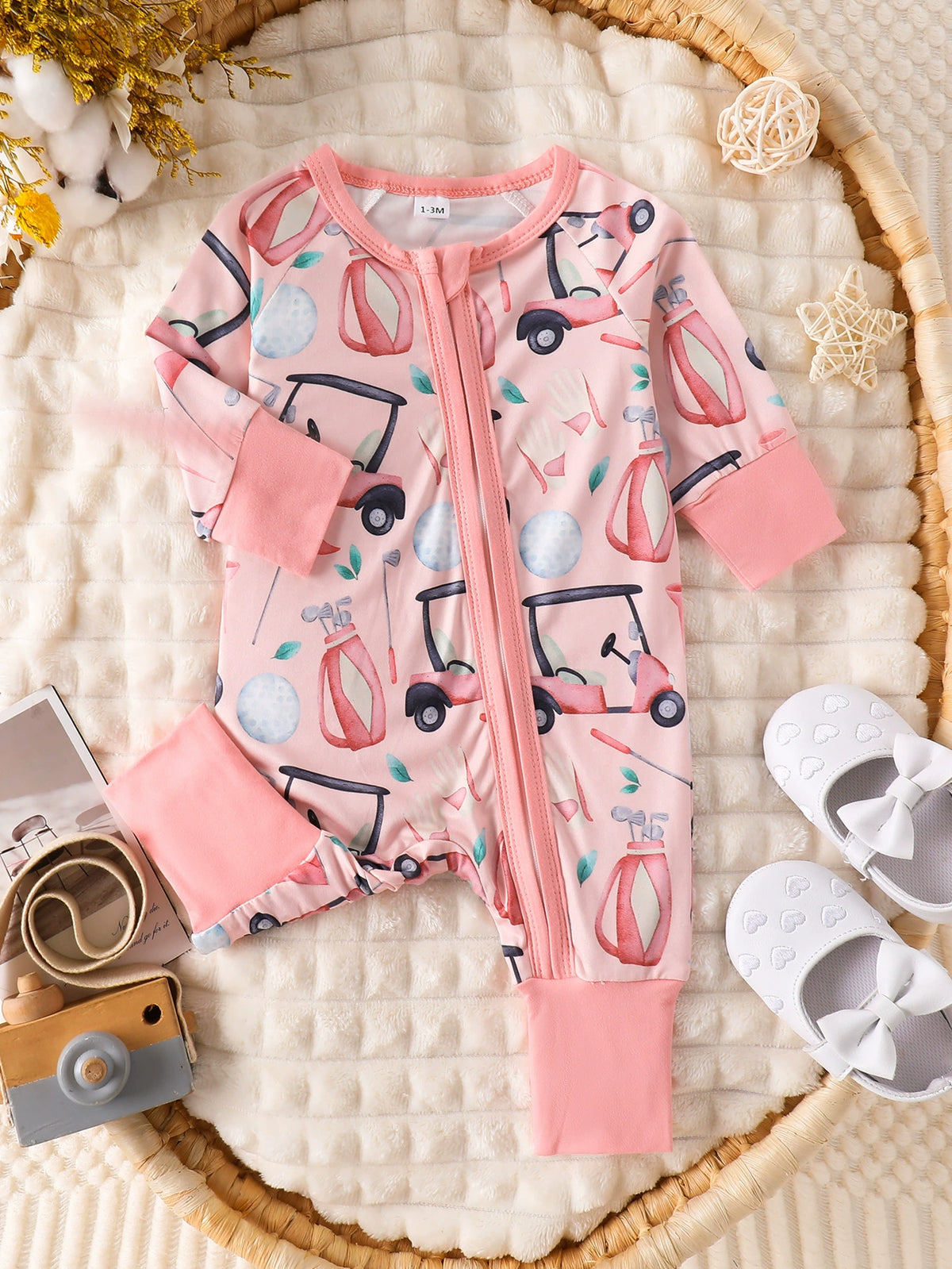 Pink golf print baby one-piece with zipper and pink cuffs