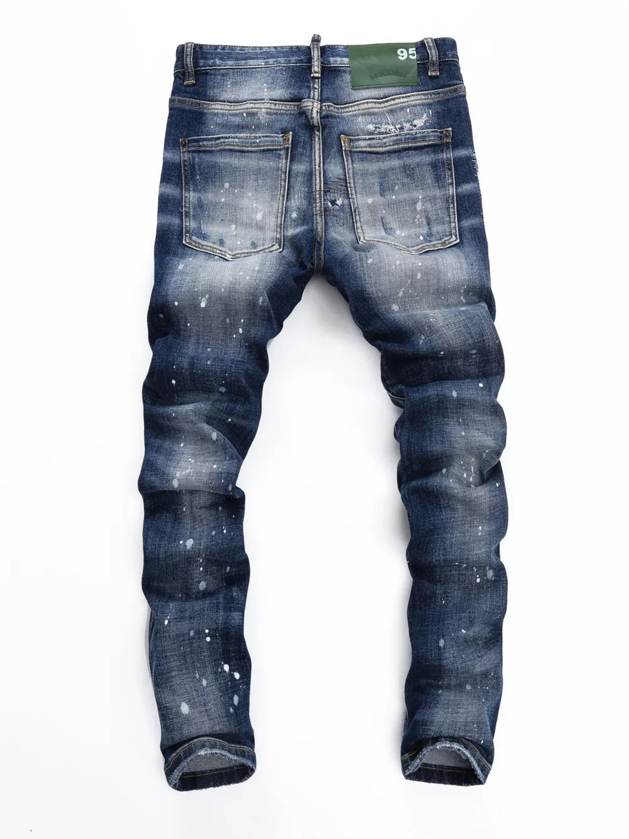 Men's dark blue slim-fit jeans with distressed details and white paint splatters.