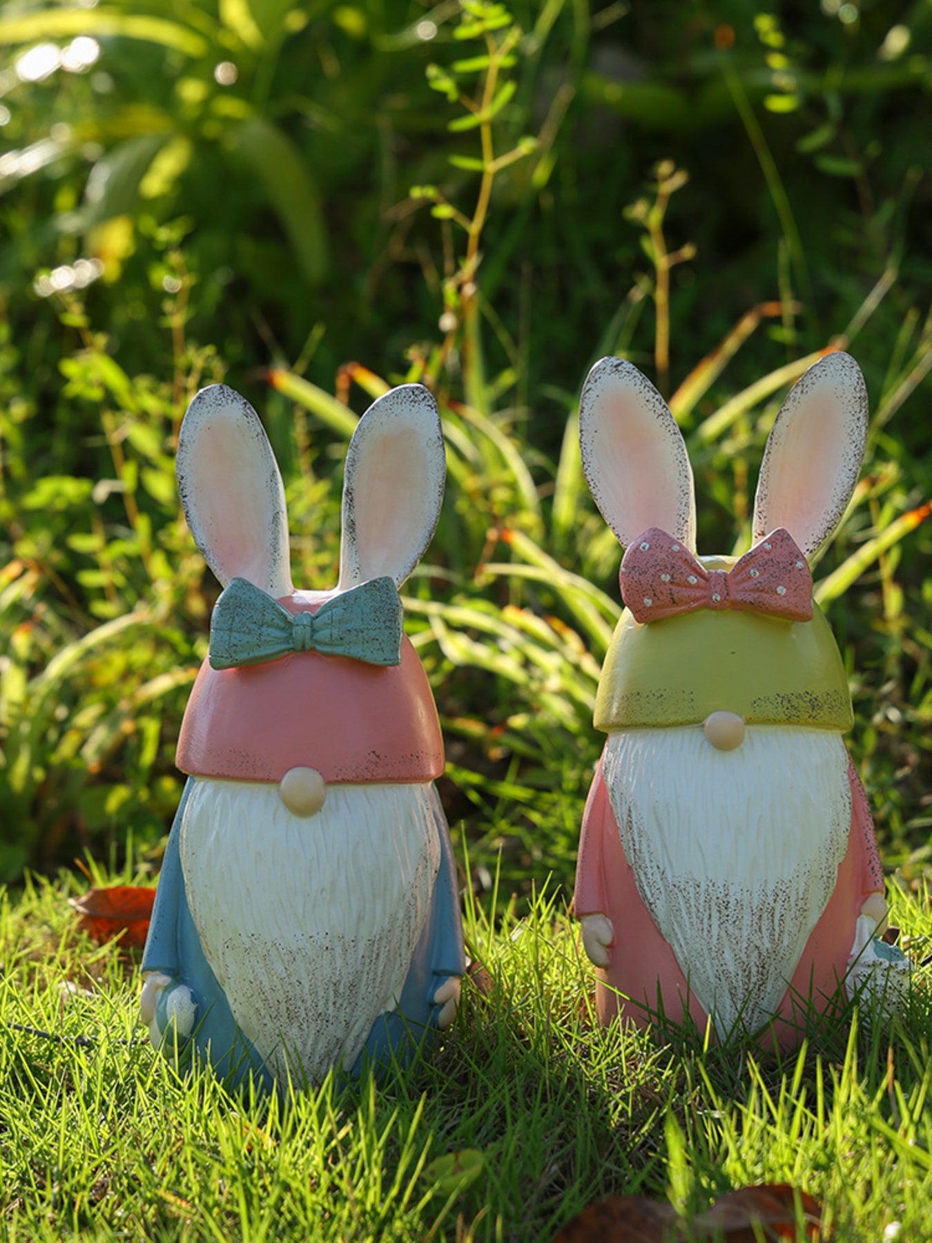 Easter Bunny gnome figures in pastel blue and blush pink with decorative bows.