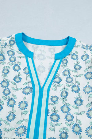 Floral dress in Pastel Blue with notched neckline, cap sleeves, and striped trim.