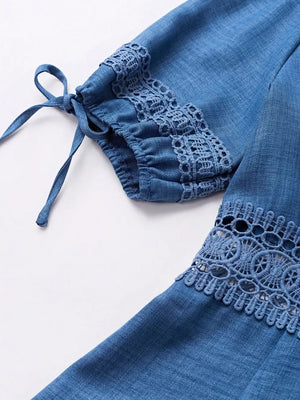 Blue denim mini dress with lace trim on sleeves and hem, featuring tie details.