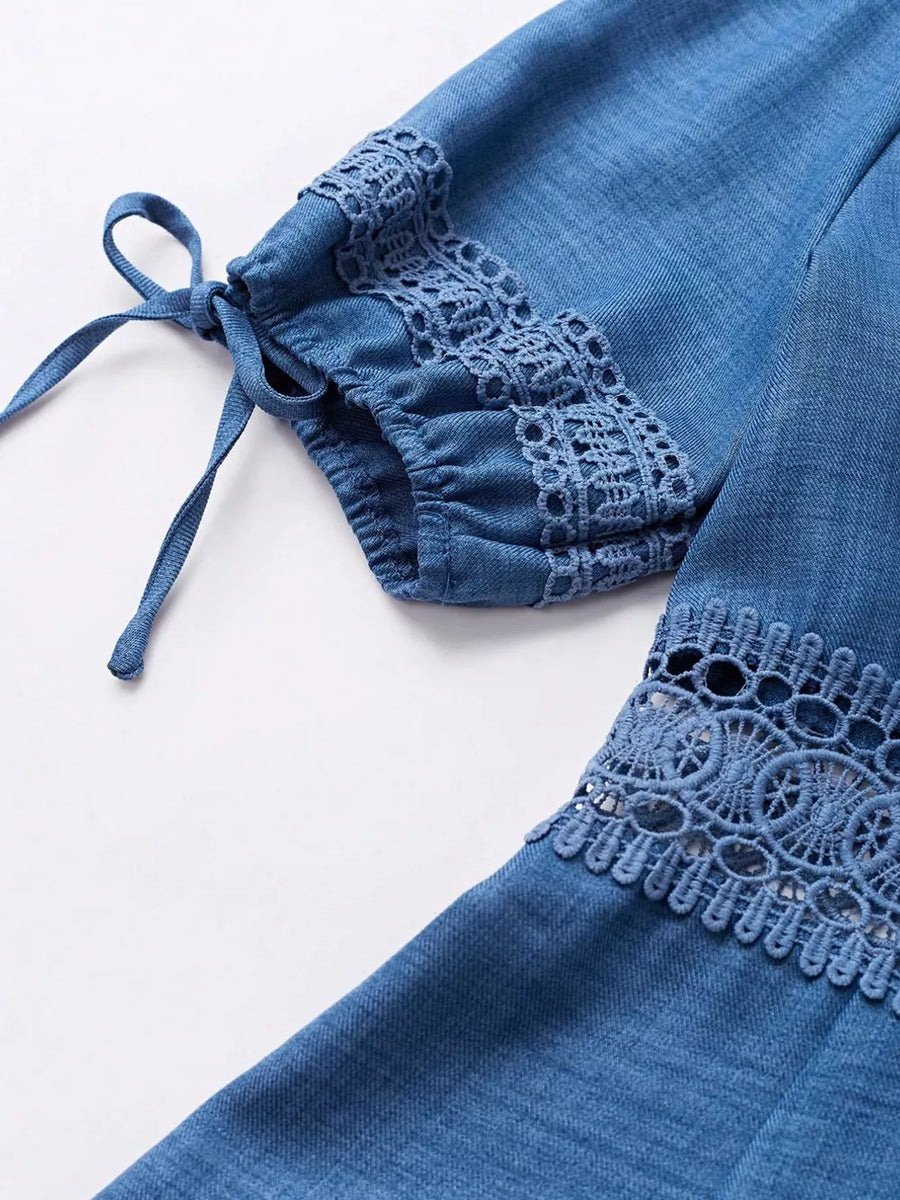 Blue denim mini dress with lace trim on sleeves and hem, featuring tie details.