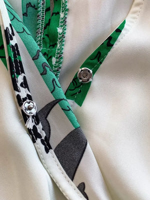 Abstract print green and white wide-leg romper with snap closure detail