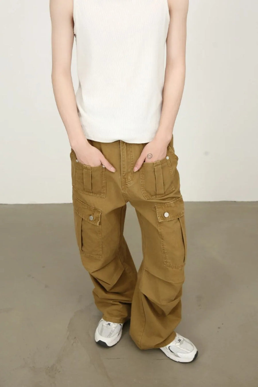 Khaki cargo trousers with wide legs and multiple pockets.