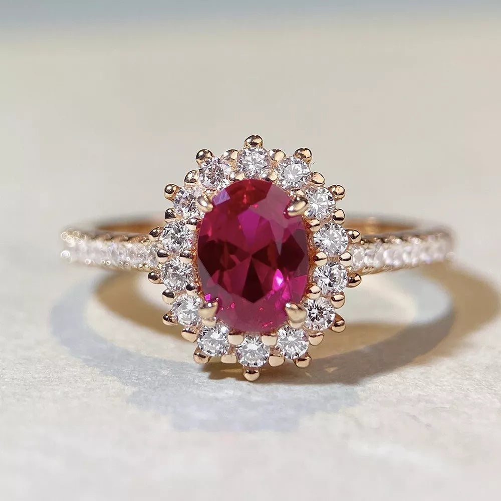 ring in ruby red featuring oval cut stone and oval fit